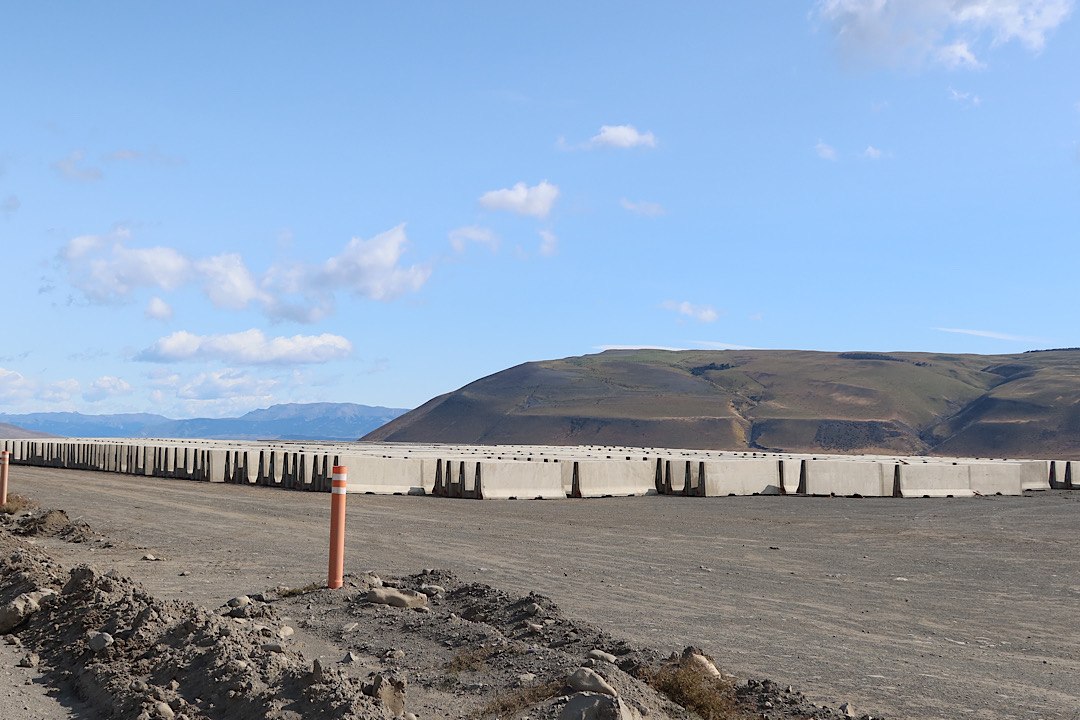 A field of concrete barriers near the end of the construction.